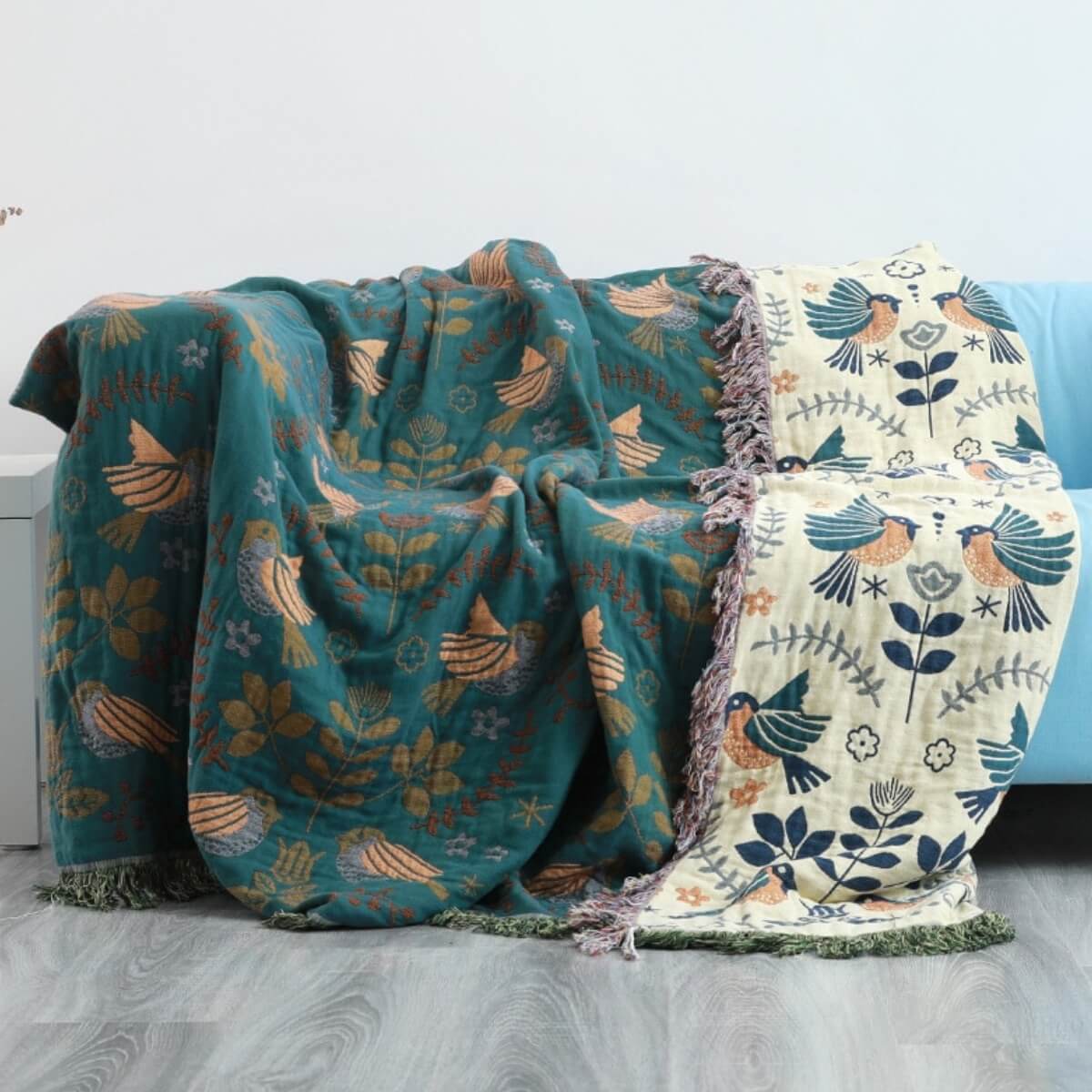 Reversible botanical patterned blanket with contrasting bird design and fringed edges
