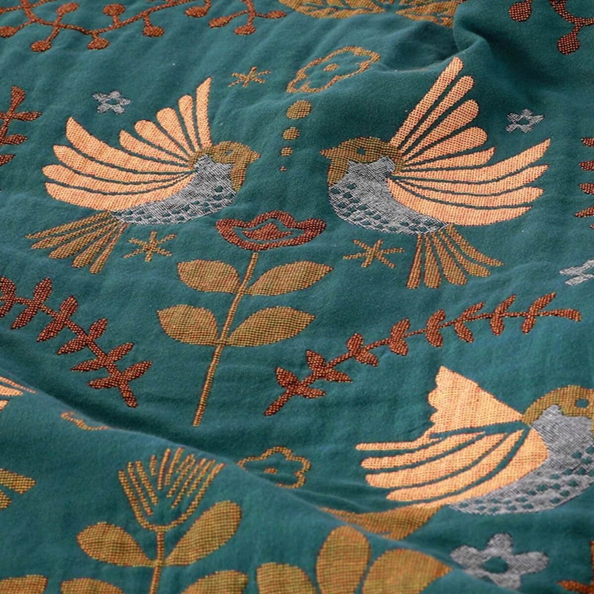 Reversible botanical patterned blanket with contrasting bird design and fringed edges
