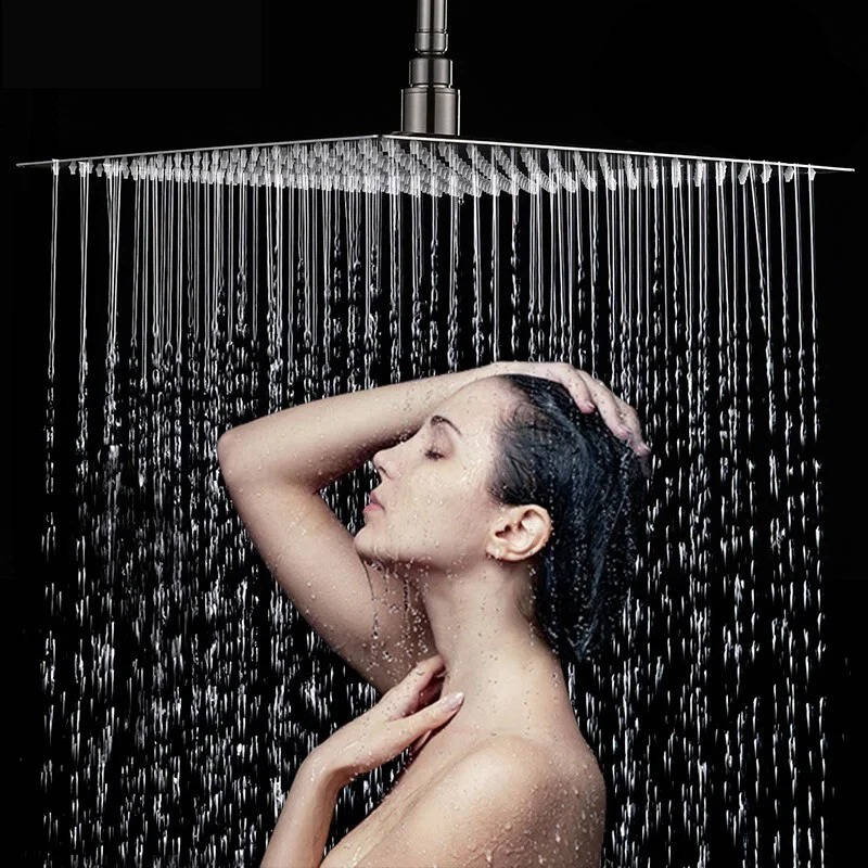 Ultra-thin silver rectangular rainfall shower head releasing an overhead water flow