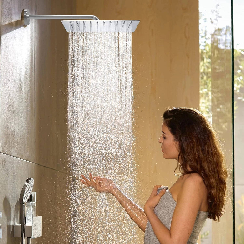Ultra-thin silver rectangular rainfall shower head releasing an overhead water flow