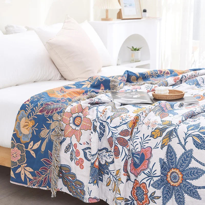 White floral blanket with colourful botanical print and fringed edge