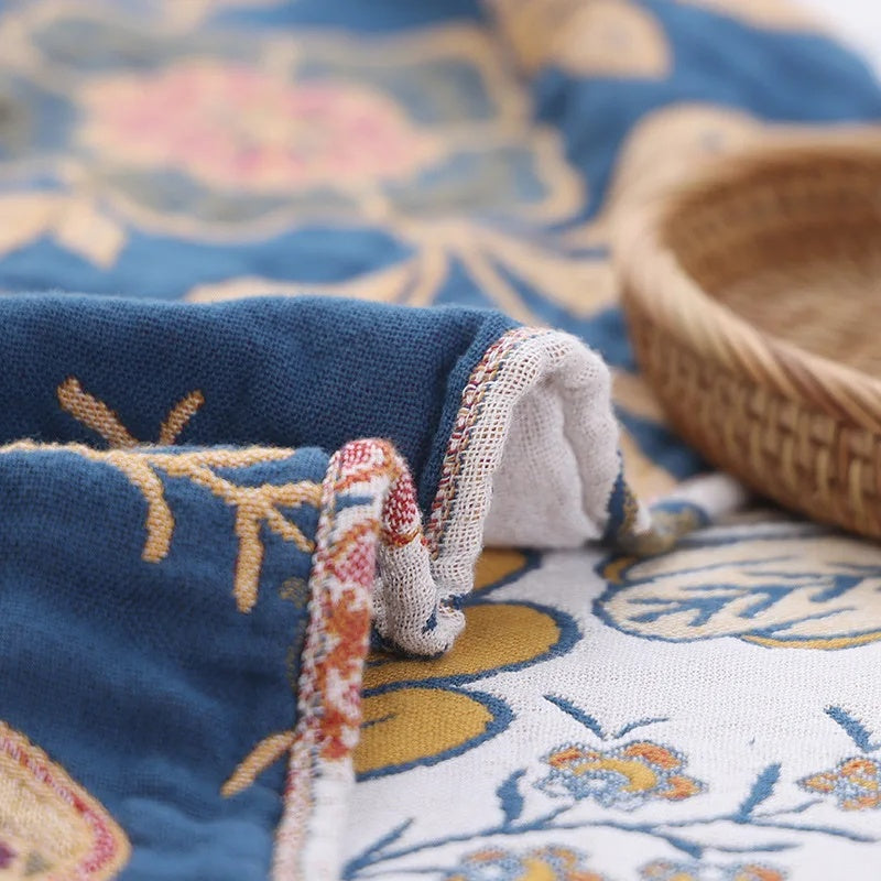 White floral blanket with colourful botanical print and fringed edge
