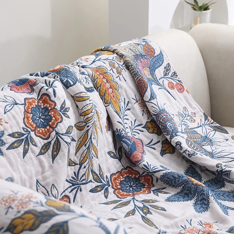 White floral blanket with colourful botanical print and fringed edge