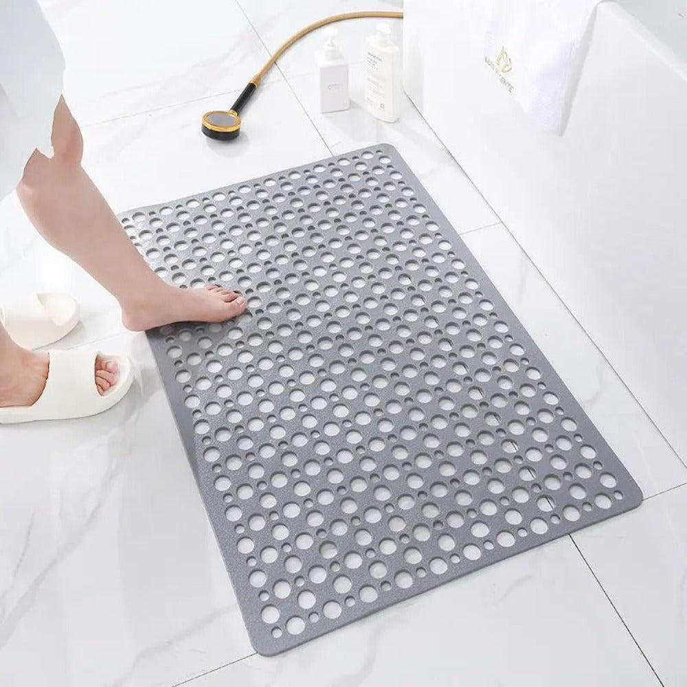 Perforated non-slip bath mat with repeated circular holes