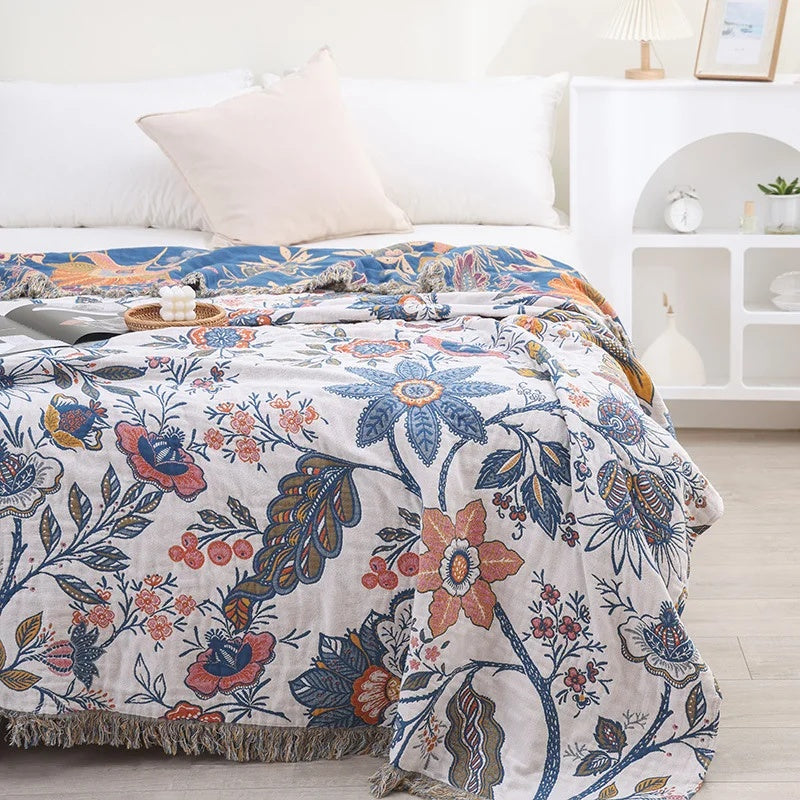 White floral blanket with colourful botanical print and fringed edge