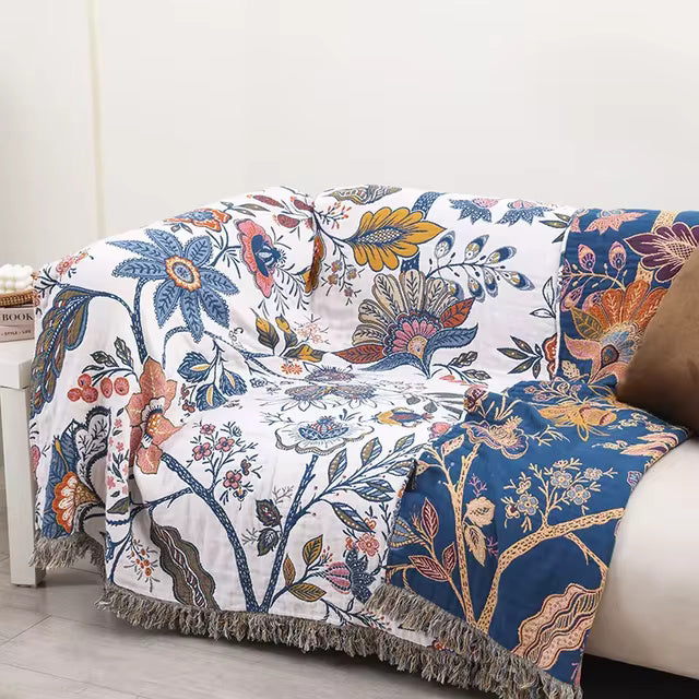 White floral blanket with colourful botanical print and fringed edge