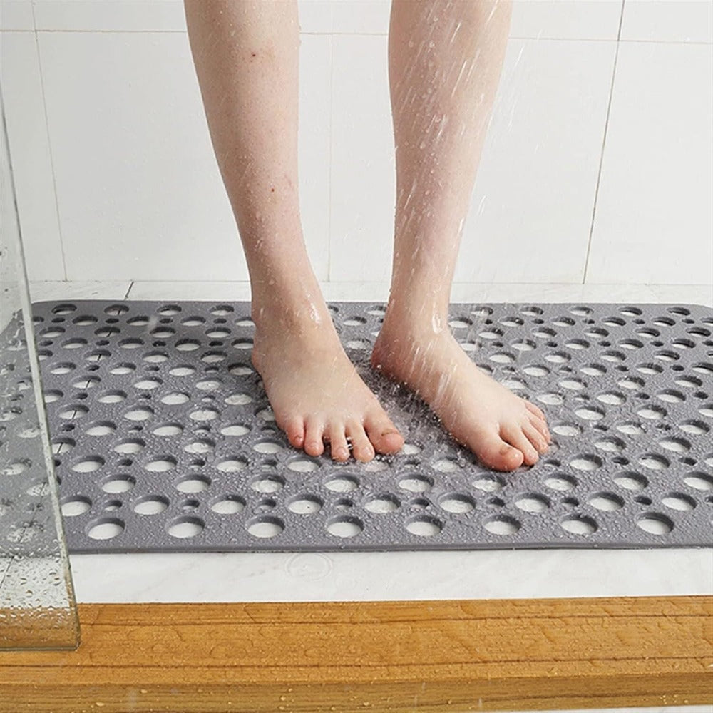 Perforated non-slip bath mat with repeated circular holes