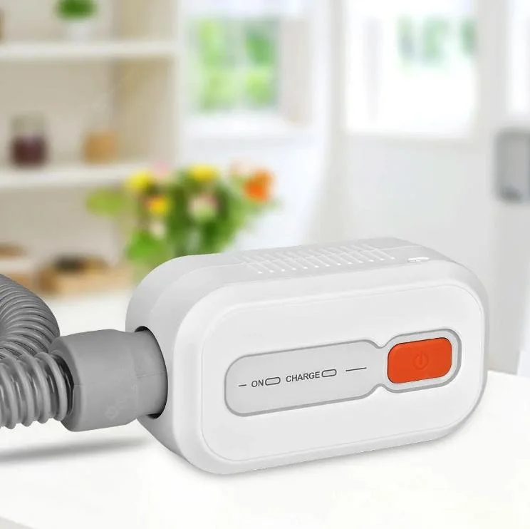 White ozone-based CPAP cleaning system with orange control button and connected hose