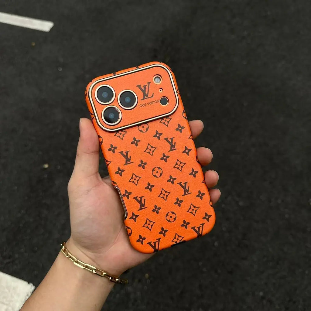 Orange iPhone 17 phone case with repeated dark monogram-style pattern and camera cut-outs