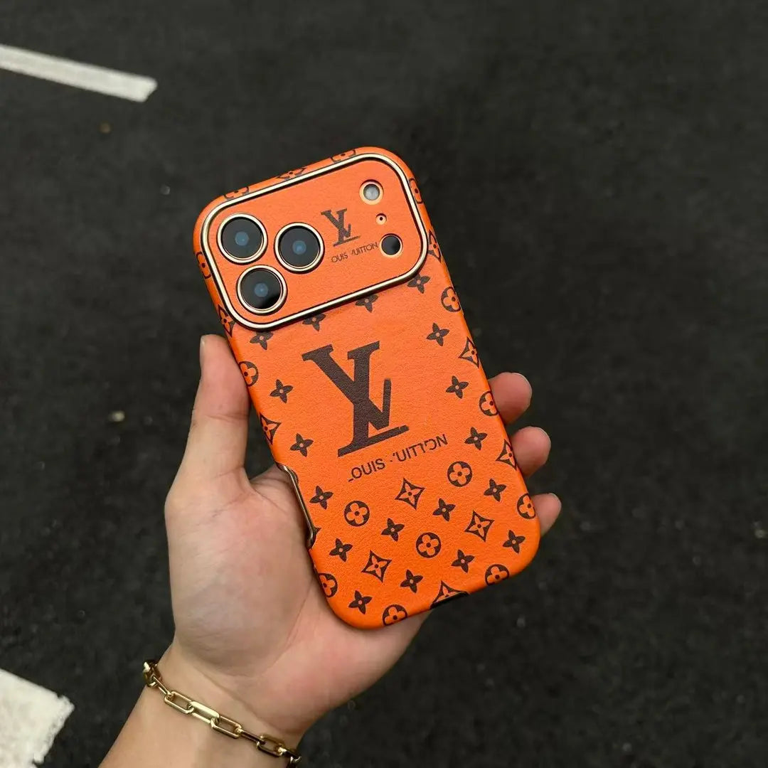 Orange iPhone 17 phone case with repeated dark monogram-style pattern and camera cut-outs