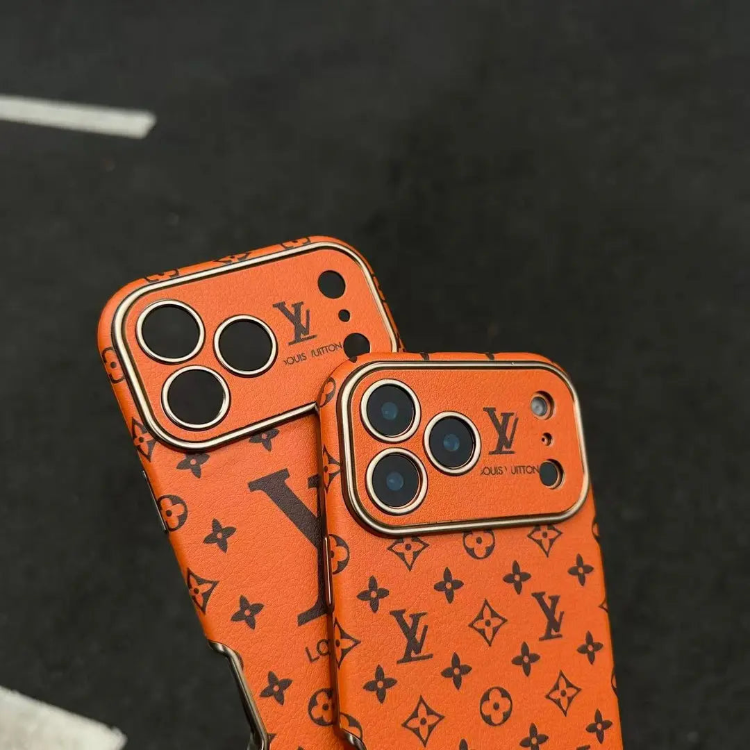Orange iPhone 17 phone case with repeated dark monogram-style pattern and camera cut-outs