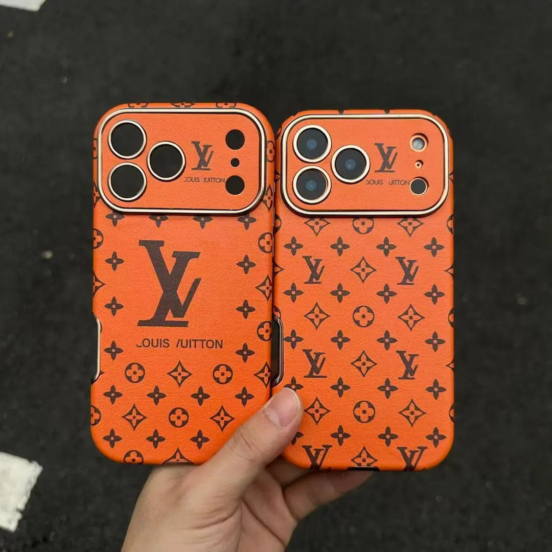 Orange iPhone 17 phone case with repeated dark monogram-style pattern and camera cut-outs