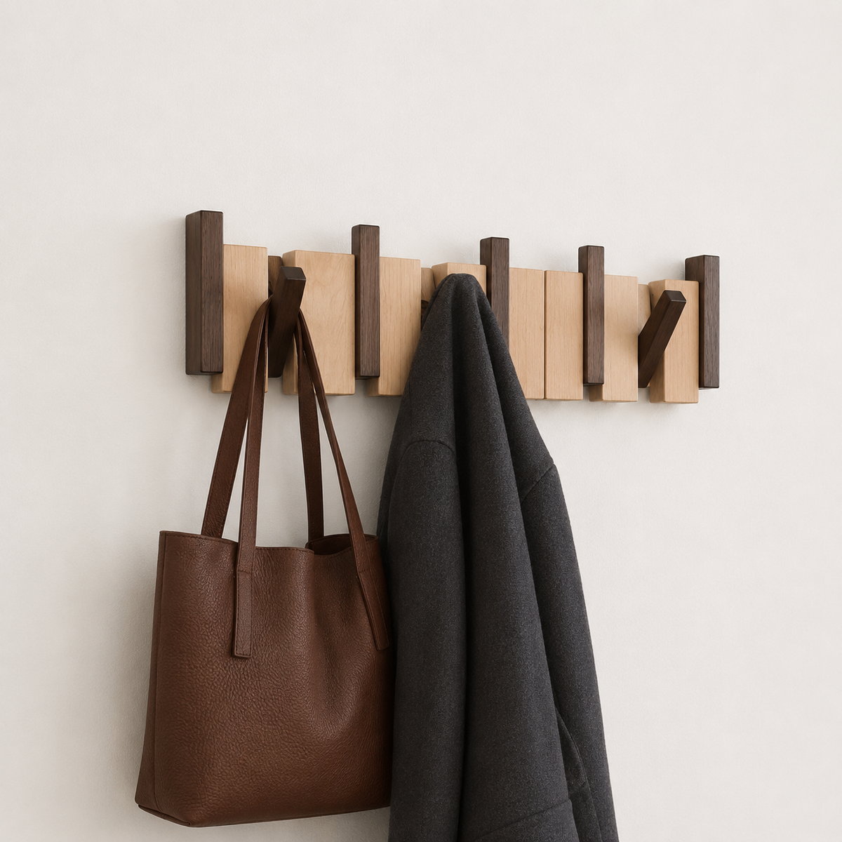 Wall mounted wooden coat rack with alternating slats and folding hooks
