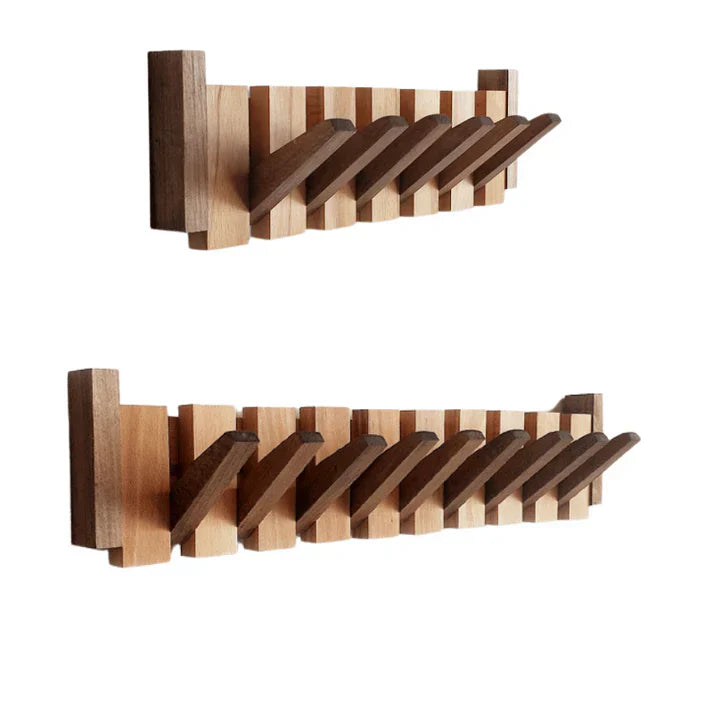 Wall mounted wooden coat rack with alternating slats and folding hooks