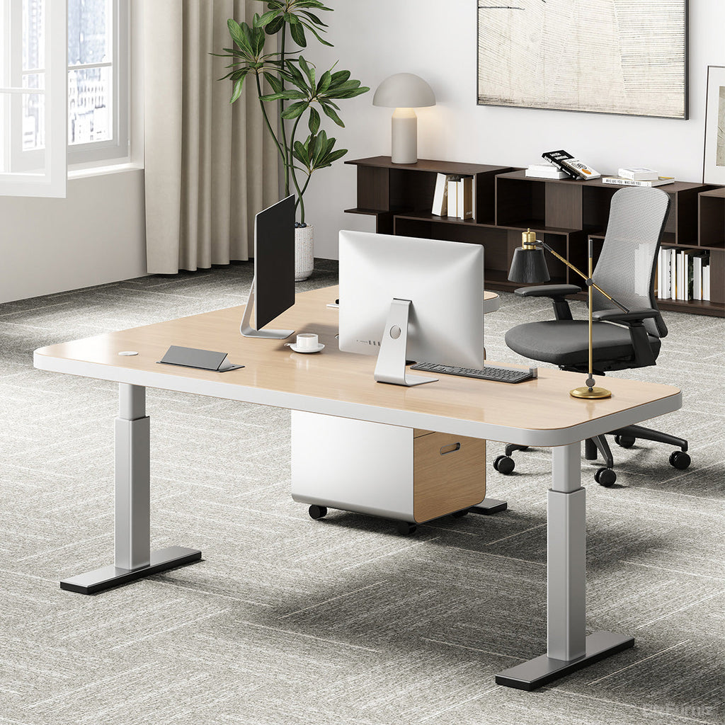 L-shaped natural wood-effect sit-stand office desk with power hub and mobile three-drawer cabinet