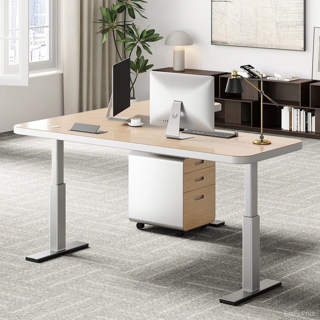 L-shaped natural wood-effect sit-stand office desk with power hub and mobile three-drawer cabinet