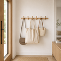 Light-brown wooden wall-mounted coat rack with multiple rounded pegs