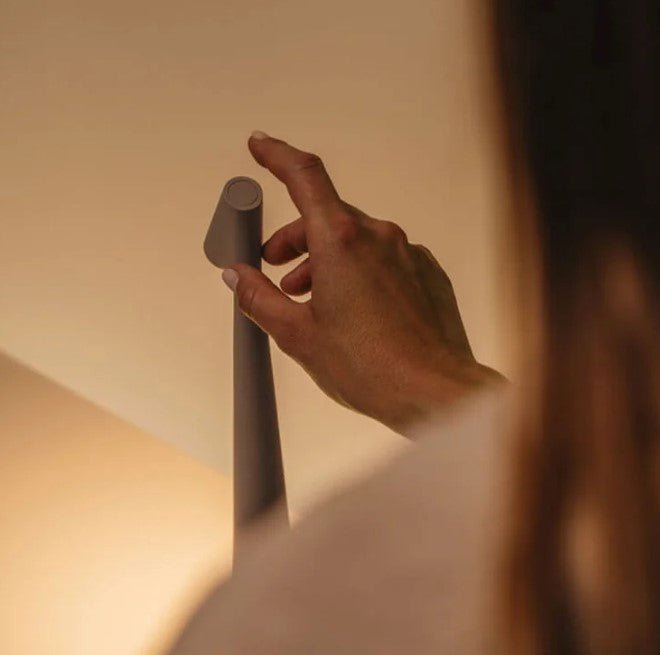 Cordless conical LED table lamp with angled light head