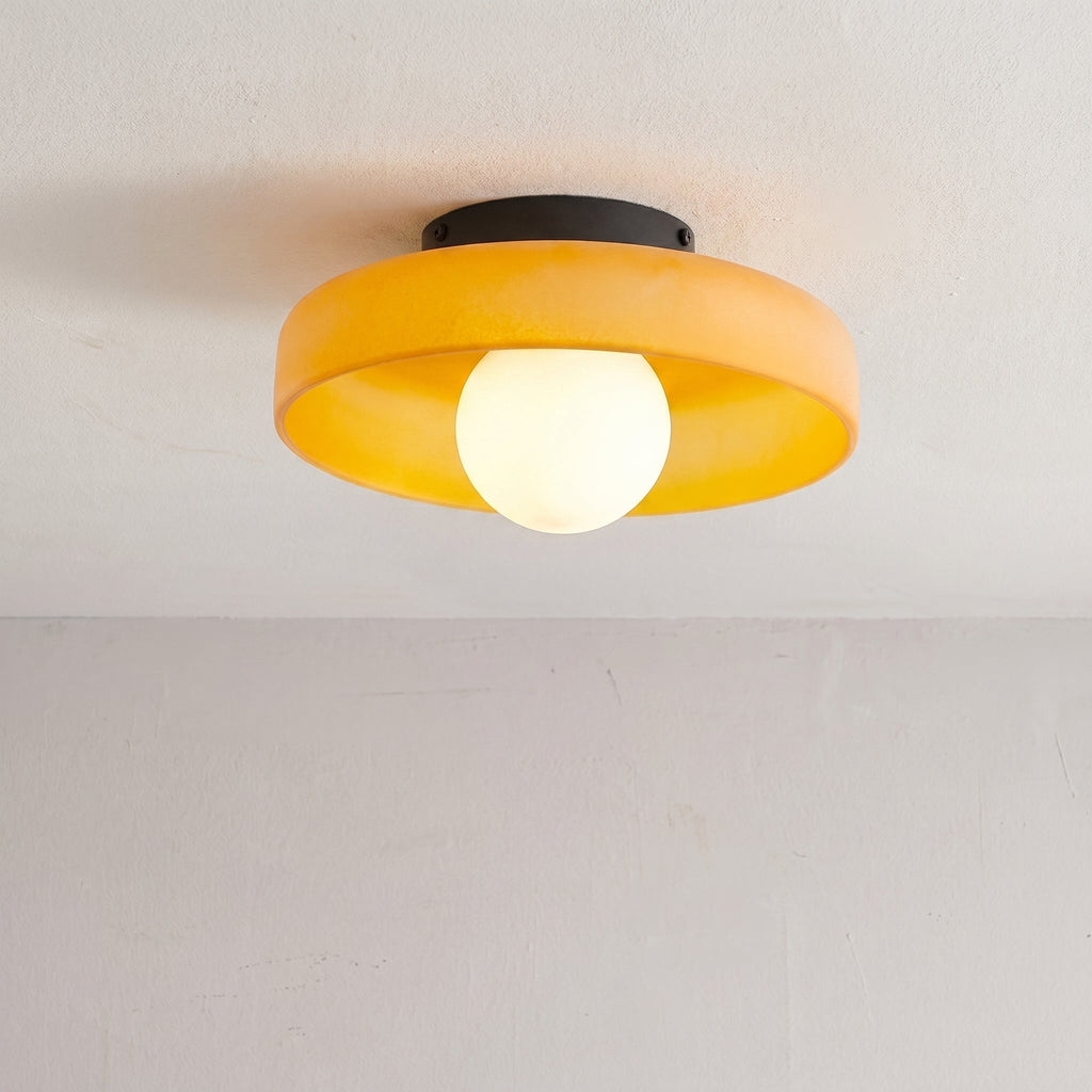 Rounded glass flush ceiling light with central white spherical diffuser