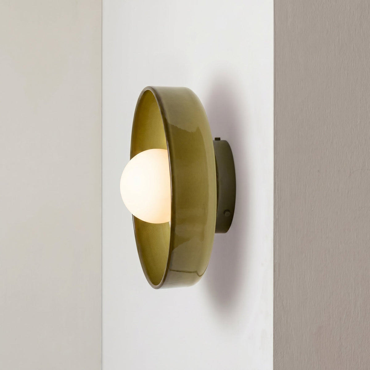 Rounded glass flush ceiling light with central white spherical diffuser