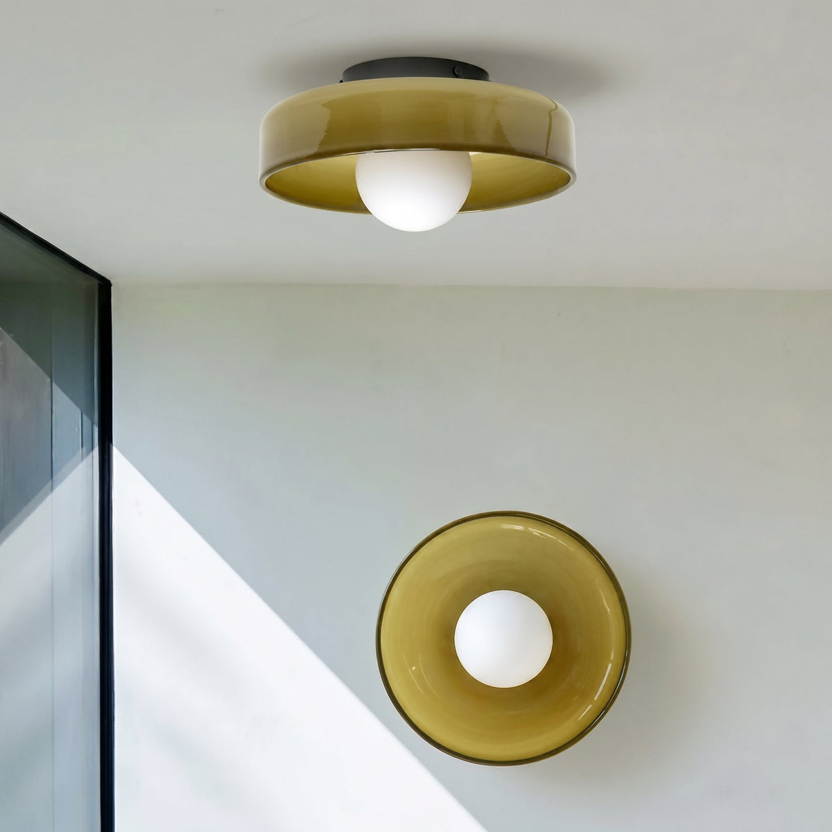 Rounded glass flush ceiling light with central white spherical diffuser