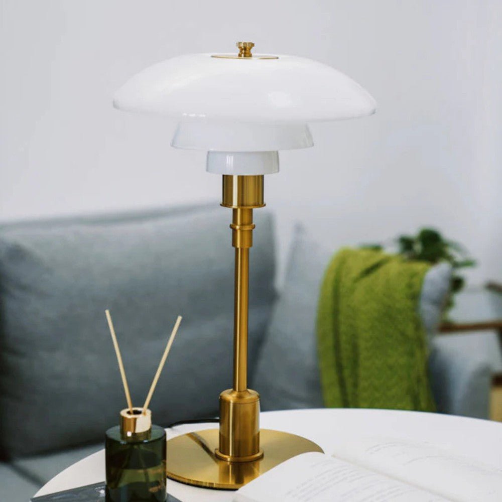 Layered glass table lamp with dome shade, slim metal stem and round base
