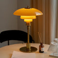 Layered glass table lamp with dome shade, slim metal stem and round base