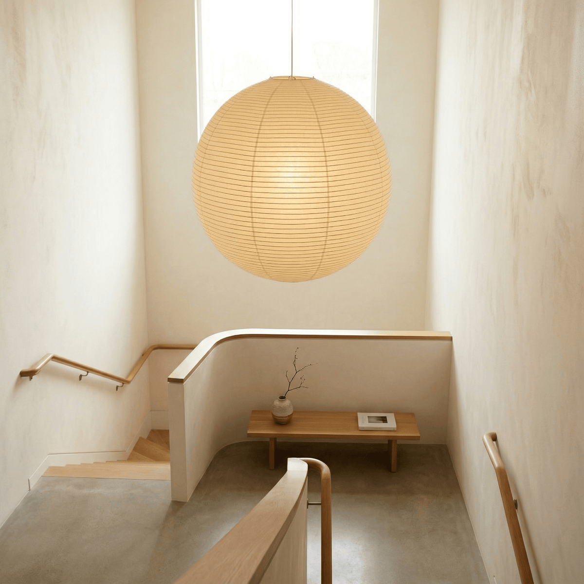 Spherical pendant light with a ribbed globe shade suspended from a ceiling