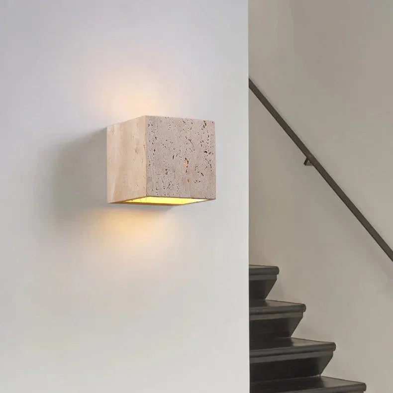 Beige travertine stone outdoor wall light casting light upwards and downwards