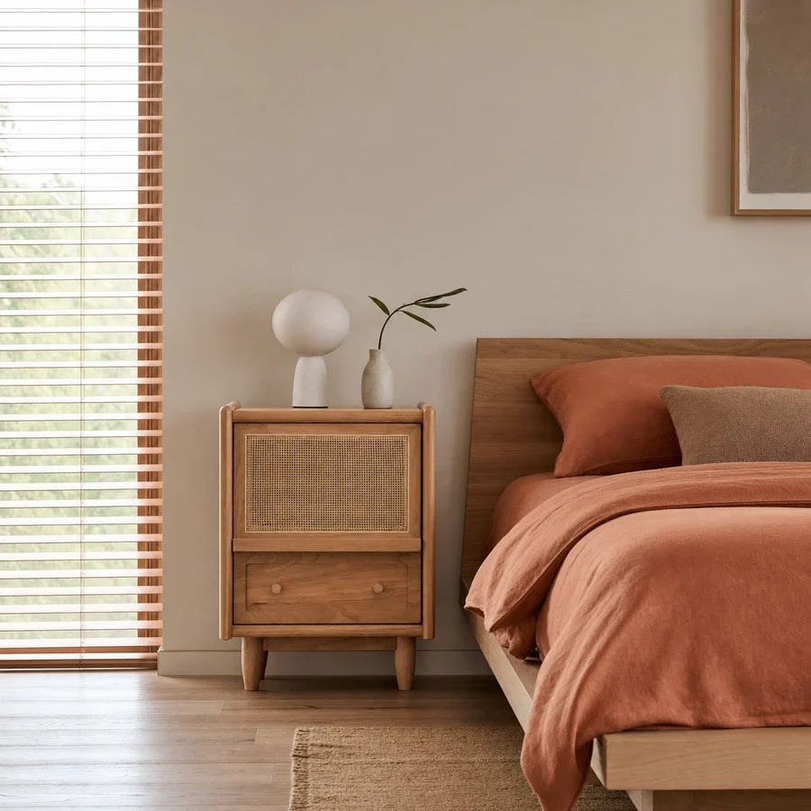 Brown wood-effect bedside table with woven front panel and drawer