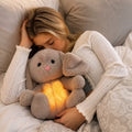 Grey rabbit stuffed animal with floppy ears and illuminated yellow belly