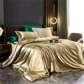 Smooth plain bedding set arranged on a bed with duvet cover, sheet and pillowcases