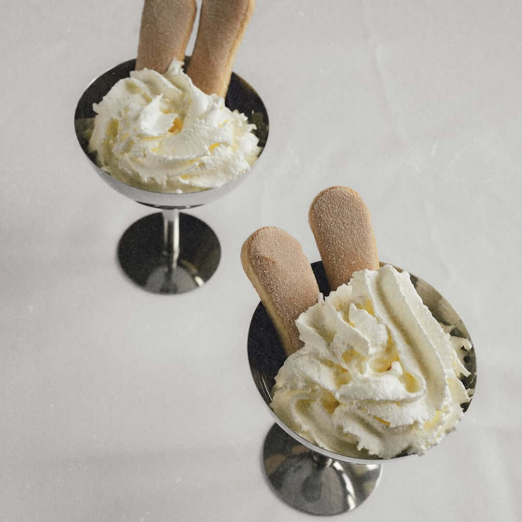 Silver stainless steel ice cream cup with a rounded bowl and pedestal base