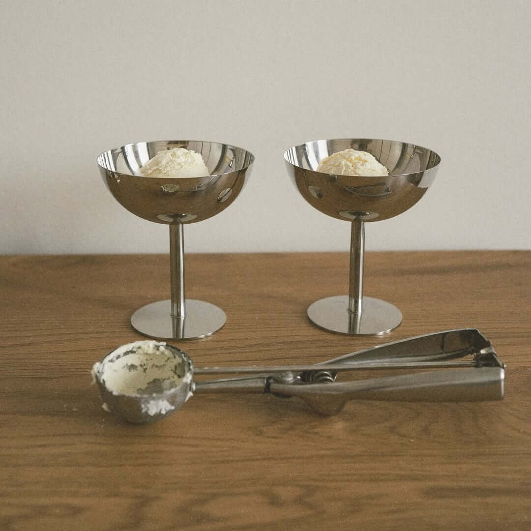 Silver stainless steel ice cream cup with a rounded bowl and pedestal base