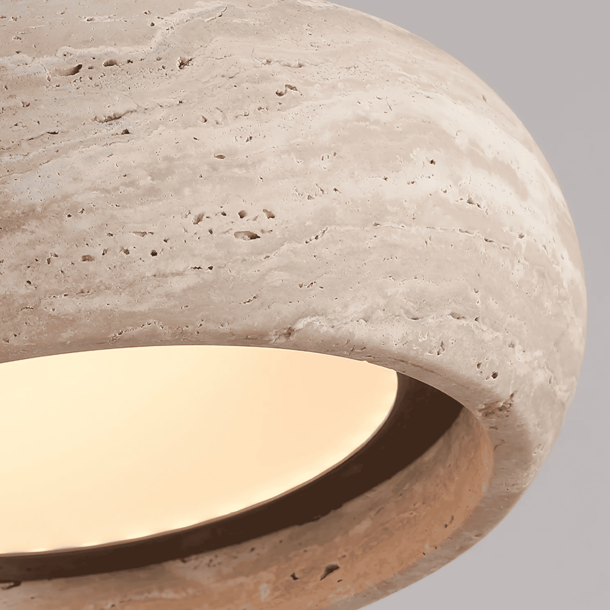Beige textured travertine pendant light with black cord and ceiling mount