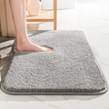 Plush rectangular bathroom mat with soft pile, rounded corners and bound edging