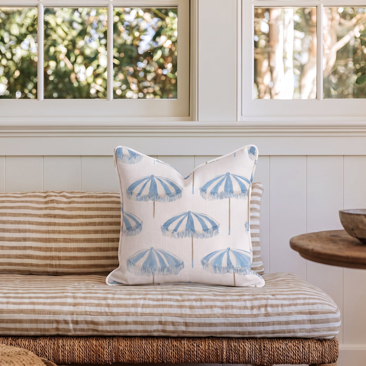 White square throw pillow with a blue umbrella pattern