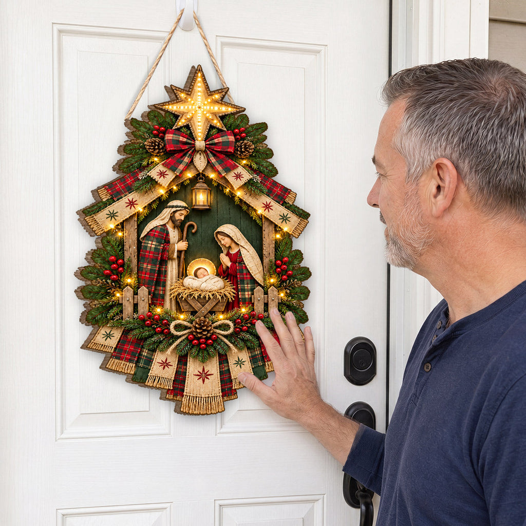 Christmas nativity door hanging decoration with star, ribbons, greenery and decorative lights