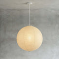 Spherical pendant light with a ribbed globe shade suspended from a ceiling