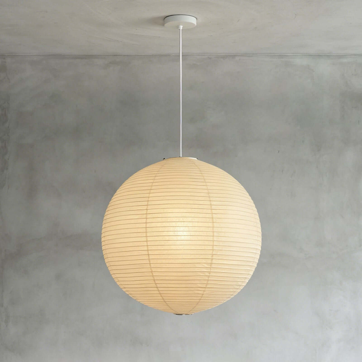 Spherical pendant light with a ribbed globe shade suspended from a ceiling